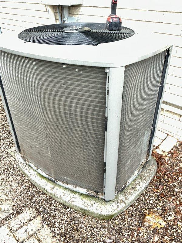 Completed annual cooling maintenance on outdoor condensing unit. Performed standard ACM procedures including inspection of cabinet, fan assembly, and refrigerant lines. Unit operational with fan guard secure and refrigerant line insulation intact. Noted minor weathering on cabinet exterior and algae growth on concrete pad, both typical for outdoor installation age. Condenser coil fins remain in good condition with adequate airflow through side panels.