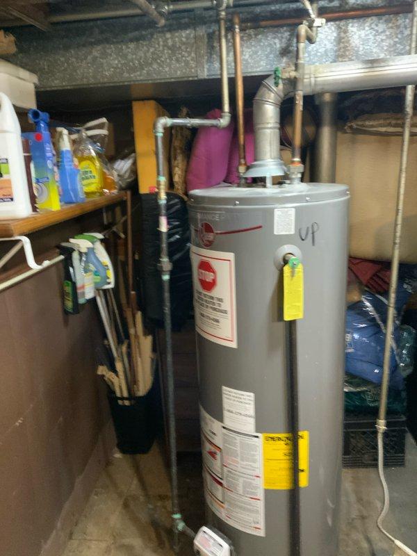 Completed estimate for replacement of two natural draft tank-style water heaters in basement utility area. Assessed existing units, measured BTU requirements to ensure proper venting compatibility with furnace sharing common chimney flue, and documented current plumbing configuration including copper supply lines and overhead connections. Provided quote for replacement installation per customer specifications.