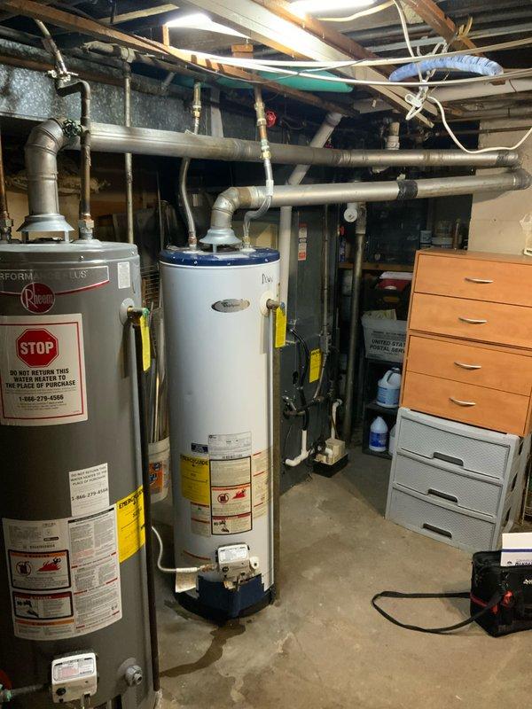 Completed estimate for replacement of two natural draft tank-style water heaters in basement utility area. Assessed existing units, measured BTU requirements to ensure proper venting compatibility with furnace sharing common chimney flue, and documented current plumbing configuration including copper supply lines and overhead connections. Provided quote for replacement installation per customer specifications.