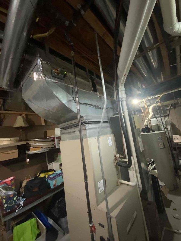 Conducted full system estimate for customer with aging 6-year-old Lennox HVAC system facing expensive repair needs. Evaluated existing outdoor condensing unit located against building exterior with overgrown vegetation requiring clearance, and inspected basement installation including furnace, air handler, and ductwork distribution system. Documented current equipment condition and configuration to provide comprehensive replacement options for immediate system upgrade consideration.