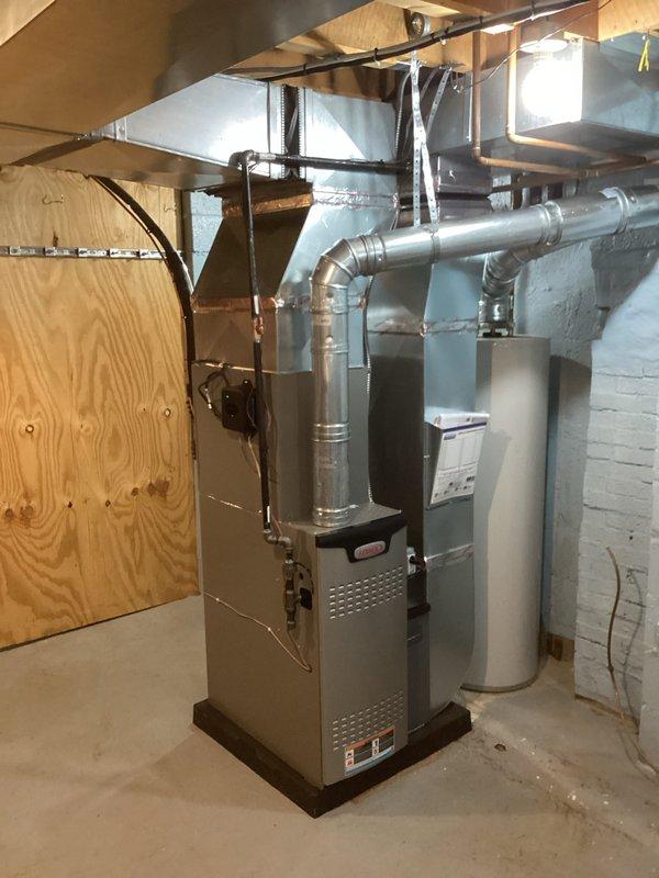 Completed full HVAC system installation including 70,000 BTU furnace and 2-ton air conditioning unit in basement utility area. Installed new furnace on platform with complete ductwork system featuring galvanized metal supply and return ducts routed through ceiling joists. Connected AC condenser with refrigerant lines and electrical service. Installed flexible and rigid ductwork with proper transitions and elbows to distribute conditioned air throughout residence. Secured all ductwork to structural framing with metal strapping and hangers. Ran electrical conduit and wiring to power units. Completed all mechanical connections and system startup. Verified proper airflow, refrigerant charge, and operational performance of both heating and cooling systems. Provided customer walkthrough of new installation explaining system operation, maintenance requirements, and thermostat controls. All work performed to code with permits obtained. System tested and operational.