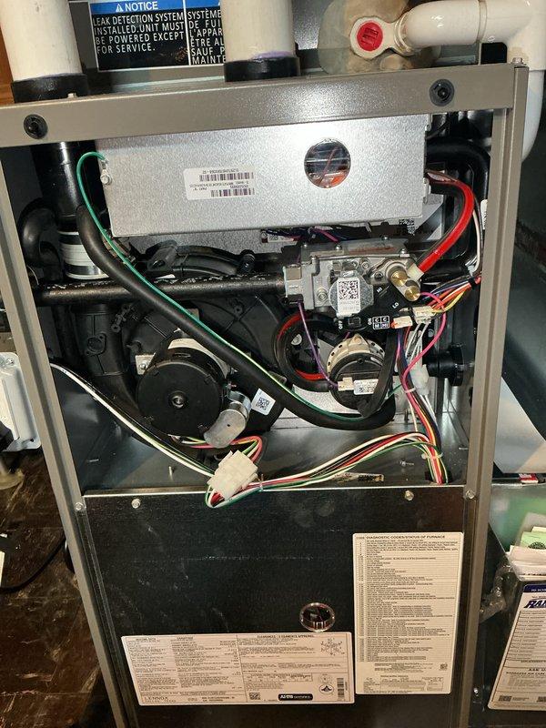 Completed comprehensive Air Care Heating and Cooling maintenance service on residential HVAC system. Inspected and serviced gas furnace, verifying proper operation of blower motor, gas valve assembly, electrical connections, and safety controls including emergency shutoff and leak detection system. Performed outdoor condensing unit inspection and noted heavy dirt and debris accumulation on mesh panels requiring cleaning to maintain optimal airflow and system efficiency.