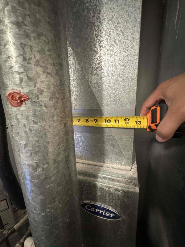 Conducted in-home estimate for replacement of 20+ year old Carrier air conditioning system. Assessed existing HVAC ductwork showing significant deterioration with flaking and peeling of outer metallic coating, documented duct dimensions, and evaluated flexible ductwork connections in mechanical space. Inspected electrical panel with Homeline breakers to verify adequate electrical capacity for new system installation, noting current panel configuration and recent inspection approval dated February 2026. Photographed equipment conditions and electrical infrastructure to provide comprehensive replacement recommendations for system upgrade scheduled within the next month.