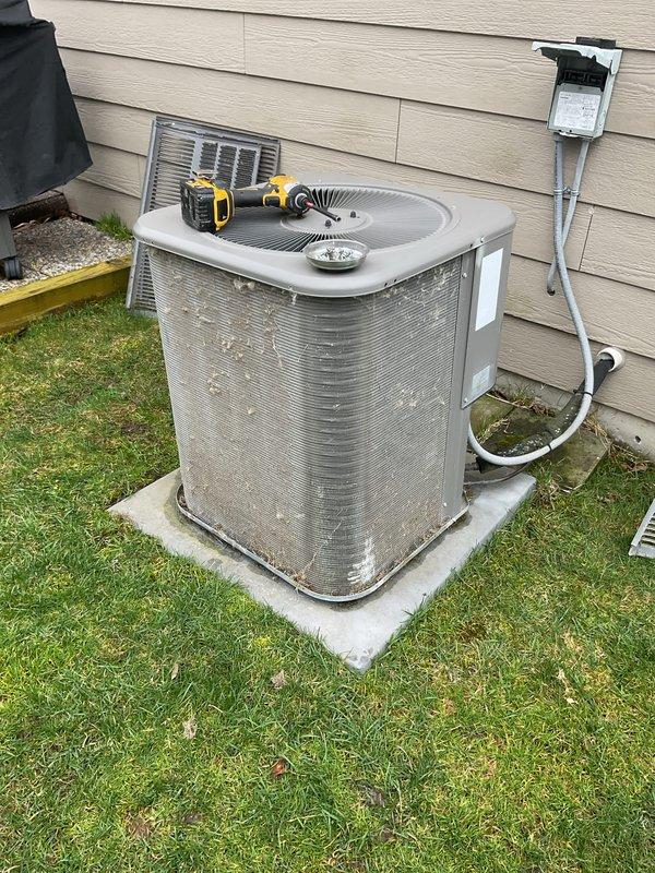Completed comprehensive preventative maintenance on residential air conditioning system per customer request. Performed full AC tune-up on outdoor condensing unit, including inspection of compressor, condenser coils, refrigerant lines, and electrical connections. Cleaned heavily soiled condenser coils and exterior surfaces which showed significant accumulation of dirt, dust, and environmental debris. Verified proper operation of fan motor and assessed copper refrigerant tubing and insulation condition. Checked electrical disconnect and power supply connections. System operating within normal parameters upon completion. Documentation captured showing unit condition before and after service. Recommended continued annual maintenance to ensure optimal performance and efficiency.
