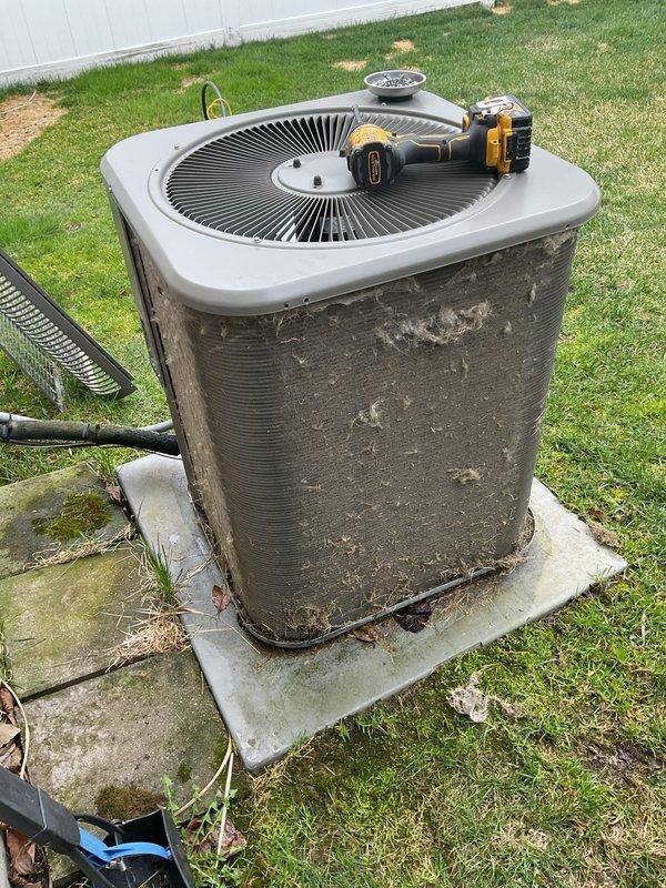 Completed comprehensive preventative maintenance on residential air conditioning system per customer request. Performed full AC tune-up on outdoor condensing unit, including inspection of compressor, condenser coils, refrigerant lines, and electrical connections. Cleaned heavily soiled condenser coils and exterior surfaces which showed significant accumulation of dirt, dust, and environmental debris. Verified proper operation of fan motor and assessed copper refrigerant tubing and insulation condition. Checked electrical disconnect and power supply connections. System operating within normal parameters upon completion. Documentation captured showing unit condition before and after service. Recommended continued annual maintenance to ensure optimal performance and efficiency.
