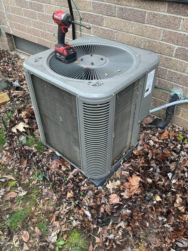 Completed annual cooling maintenance on residential outdoor condenser unit. Performed comprehensive inspection of unit exterior, verified fan grille condition, and measured discharge air temperature at 50.5°F. Cleared accumulated leaves and debris from around unit base and perimeter to ensure proper airflow and system efficiency.