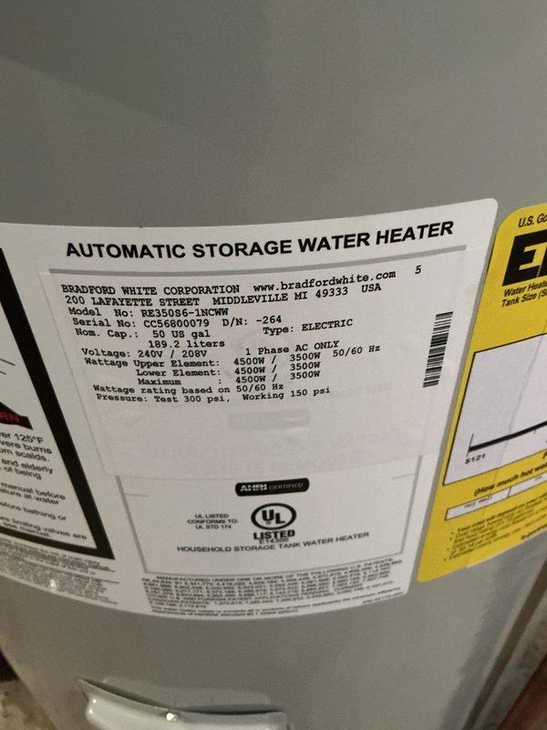 Installed a Bradford White 50-gallon electric water heater, model RE350S6-1NCWM, rated at 240/208 volts with 4500W/3500W heating elements. Connected copper supply lines, electrical wiring with conduit, and verified proper pressure relief valve installation. Unit was installed in basement utility area alongside existing well pressure tank, with all connections completed to code and system tested for proper operation.