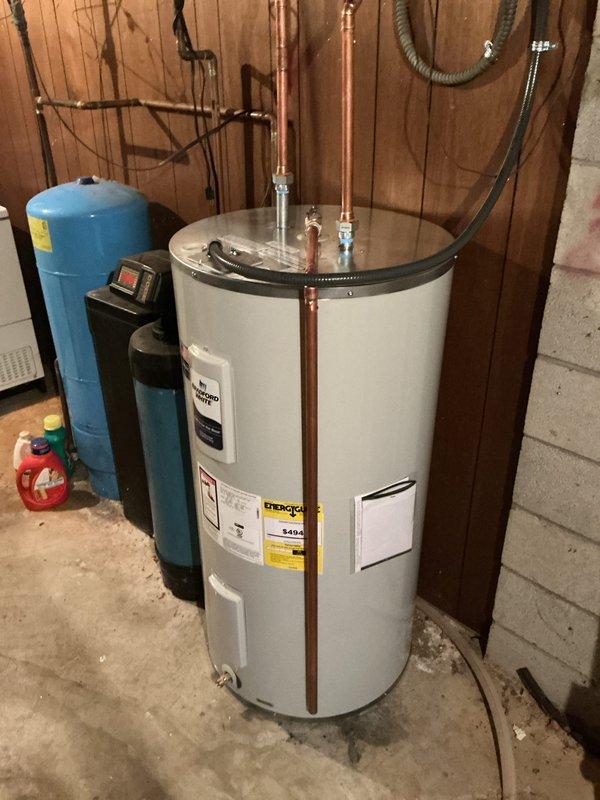 Installed a Bradford White 50-gallon electric water heater, model RE350S6-1NCWM, rated at 240/208 volts with 4500W/3500W heating elements. Connected copper supply lines, electrical wiring with conduit, and verified proper pressure relief valve installation. Unit was installed in basement utility area alongside existing well pressure tank, with all connections completed to code and system tested for proper operation.