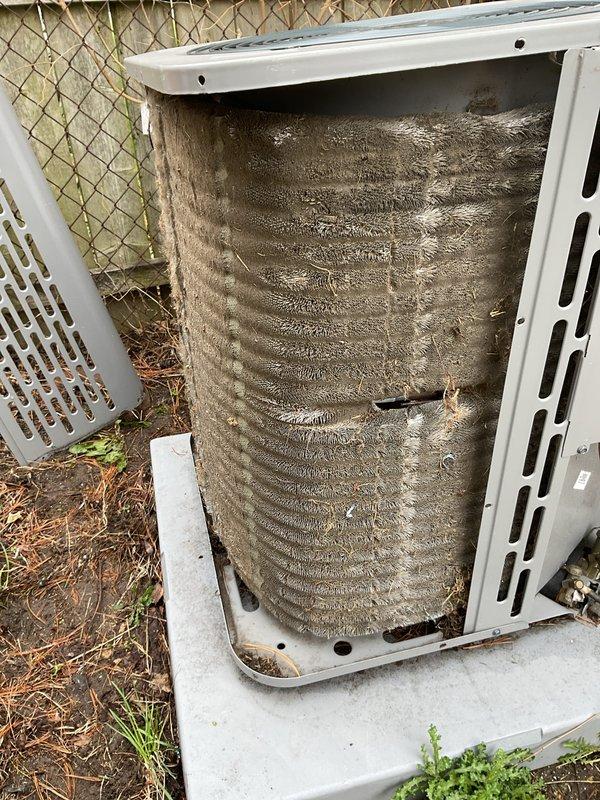 Performed scheduled maintenance on outdoor ACM unit. Removed side access panel to inspect internal coil assembly, which revealed heavy accumulation of dirt, dust, and debris throughout the evaporator/condenser coils. The buildup had significantly reduced airflow capacity and heat transfer efficiency. Documented pre-service condition showing thick coating on fin surfaces and between coil fins. Unit required thorough coil cleaning to restore proper system performance and airflow.
