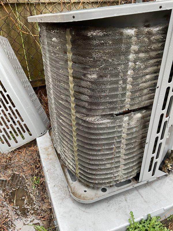 Performed scheduled maintenance on outdoor ACM unit. Removed side access panel to inspect internal coil assembly, which revealed heavy accumulation of dirt, dust, and debris throughout the evaporator/condenser coils. The buildup had significantly reduced airflow capacity and heat transfer efficiency. Documented pre-service condition showing thick coating on fin surfaces and between coil fins. Unit required thorough coil cleaning to restore proper system performance and airflow.
