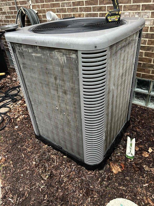 Performed annual cooling maintenance on outdoor condenser unit. Inspected unit exterior condition, noting weathering and debris accumulation on coil surfaces. Documented equipment status with photographs for service records.