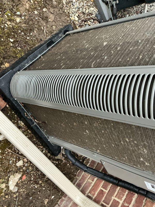 Completed scheduled Air Care Heating and Cooling maintenance on outdoor HVAC unit. Inspected heat exchanger coils, verified system components, and documented unit condition with photographs showing normal weathering and minor debris accumulation on fins and surfaces.