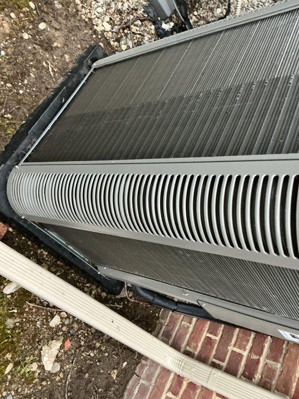 Completed scheduled Air Care Heating and Cooling maintenance on outdoor HVAC unit. Inspected heat exchanger coils, verified system components, and documented unit condition with photographs showing normal weathering and minor debris accumulation on fins and surfaces.