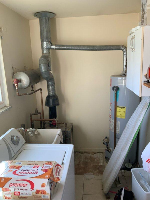 Provided estimate for complete HVAC system installation including furnace and air conditioning unit to replace existing 45+ year old baseboard heating system. Equipment to be located in laundry room at rear of residence. Assessed utility closet containing water heater, expansion tank, and existing ductwork infrastructure. Evaluated space constraints and mechanical room layout to determine optimal placement for new forced-air heating and cooling equipment, including required modifications to accommodate ductwork distribution system throughout home.