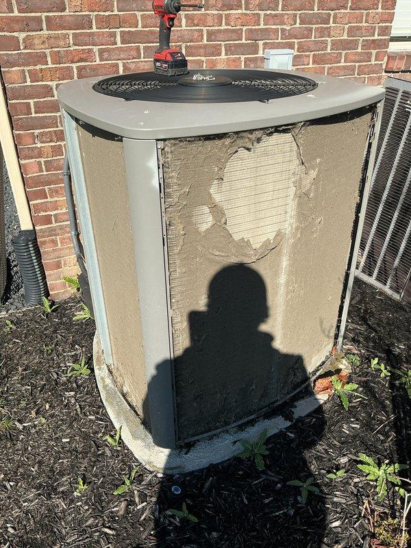 Completed annual preventive maintenance on residential split system air conditioning unit. Performed comprehensive inspection of outdoor condenser unit, noting significant exterior panel damage with multiple sections of outer casing torn or missing, exposing underlying insulation material. Despite cosmetic damage to cabinet, unit operational components assessed and system functionality verified during routine ACM service protocol.