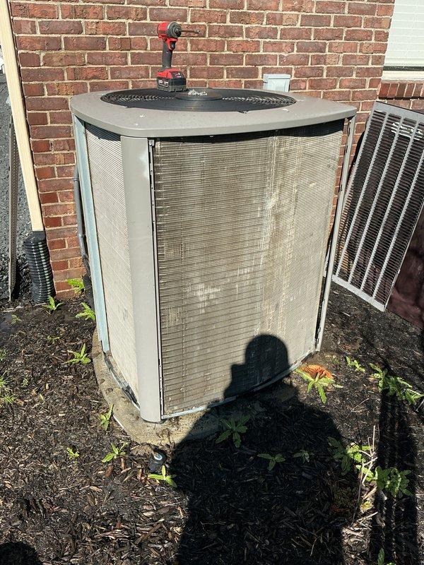 Completed annual preventive maintenance on residential split system air conditioning unit. Performed comprehensive inspection of outdoor condenser unit, noting significant exterior panel damage with multiple sections of outer casing torn or missing, exposing underlying insulation material. Despite cosmetic damage to cabinet, unit operational components assessed and system functionality verified during routine ACM service protocol.