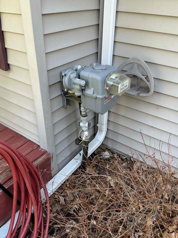 Conducted on-site evaluation for whole home generator installation, assessing existing natural gas meter location and electrical service panel placement. Documented current utility infrastructure including gas meter assembly with multiple connection points and 200-amp electrical service, evaluated clearance requirements and optimal placement area adjacent to HVAC unit on concrete pad, and provided estimate options for both Kohler and Generac generator systems with automatic transfer switch integration.