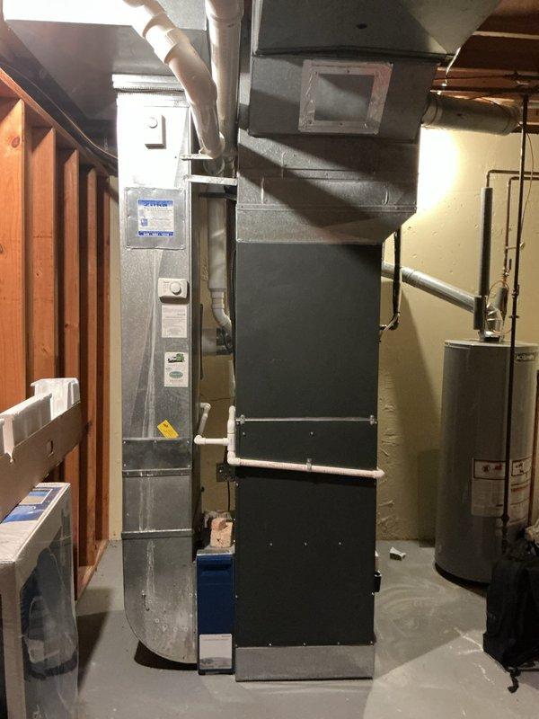 Completed annual HVAC maintenance inspection on residential forced-air heating system and associated mechanical equipment. Identified need for air filter replacement due to spots on existing filter, documented equipment condition including furnace unit, ductwork connections, and water heater installation with photographic records for service history.