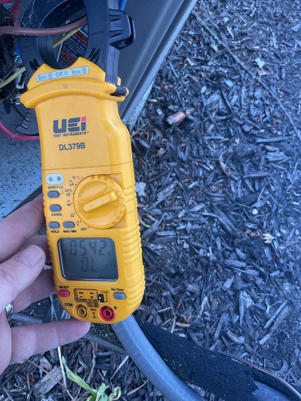 Performed scheduled air conditioning maintenance on residential cooling system. Conducted electrical measurements using digital clamp meter to verify proper amperage draw on compressor and system components, confirming unit operating within manufacturer specifications. All readings documented and system found to be functioning correctly with no deficiencies noted.