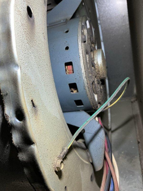 Responded to no heat call on 16-year-old forced air furnace that would run for one minute after reset button was pressed, then shut down. Diagnosed failed run capacitor using clamp meter, which showed capacitance reading of 0.067 microfarads, well below manufacturer specifications. Removed defective capacitor from blower assembly and replaced with new OEM-equivalent component. Tested system operation through multiple heating cycles to verify proper blower motor startup and continuous operation. System restored to full heating functionality.