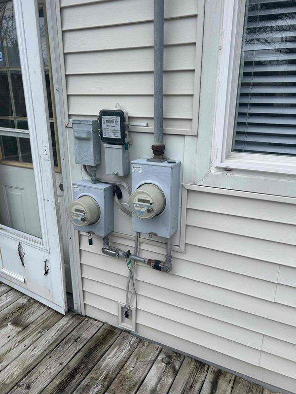 Provided comprehensive estimate for replacement of existing HVAC system including 10-year-old natural gas furnace, 30-year-old air conditioning unit, and 15-year-old water heater, all located on main level. Assessment included evaluation of existing ductwork system showing signs of age and dust accumulation, as well as inspection of exterior electrical service panel and dual meter configuration to determine electrical capacity requirements for new equipment installation. Estimate encompasses necessary electrical upgrades to support modern high-efficiency equipment replacement.