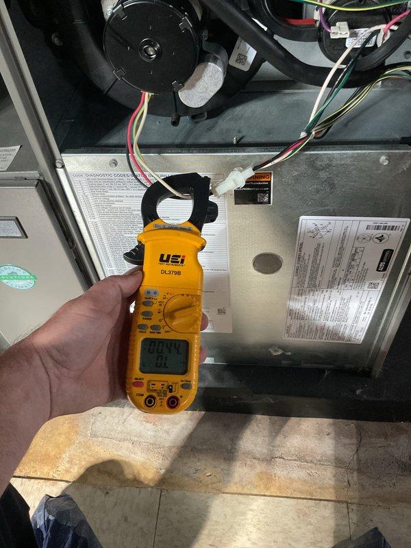 Completed comprehensive ComfortGuard Maintenance service on HVAC system, including installation of two furnace filters and humidifier pad replacement. Performed diagnostic testing using digital multimeter to verify proper electrical readings at gas valve assembly and measured amperage draw on blower motor to ensure system operating within manufacturer specifications. All components inspected and confirmed functioning correctly.