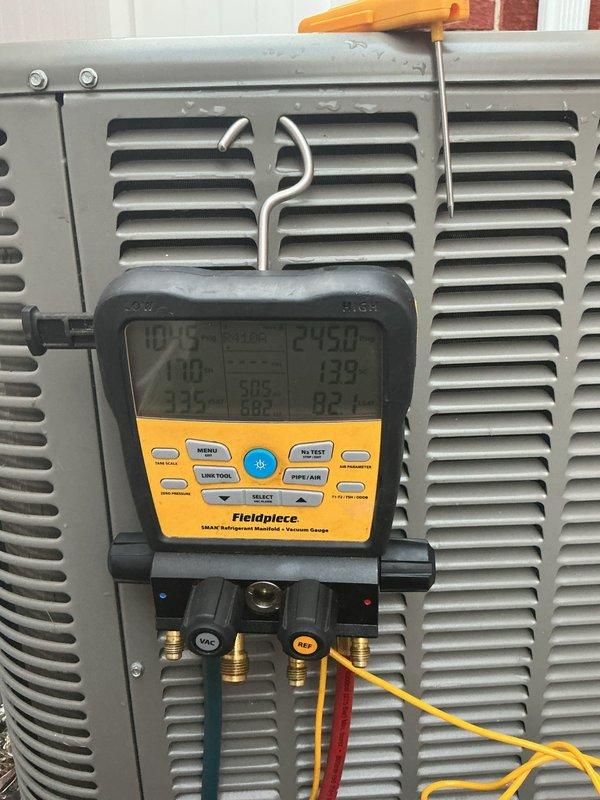 Completed routine ACM maintenance on residential air conditioning system. Connected diagnostic manifold gauges to measure system pressures and temperatures, verifying refrigerant charge and operational parameters. Observed heavy dirt and debris accumulation on condenser coils requiring attention. Documented equipment condition with photos showing significant contamination affecting heat transfer efficiency on outdoor unit.