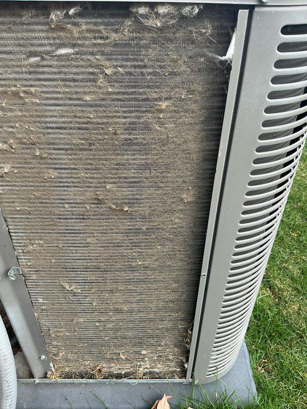 Completed scheduled air conditioning maintenance on outdoor condensing unit. Removed access panels to inspect condenser coil, which showed significant accumulation of dirt, dust, and organic debris throughout the fin surfaces. Cleaned condenser coil thoroughly to restore proper airflow and heat transfer efficiency. Replaced air filter and evaporator pad as part of routine maintenance protocol. Unit returned to normal operation with improved cooling performance.