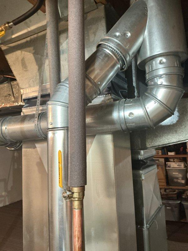 Successfully installed a 40-gallon residential tanked water heater in basement utility area. Connected copper supply lines, installed proper venting with galvanized ductwork including elbow joints and secure clamp bands, and completed all reconnections to existing plumbing system. All mechanical connections tested and verified operational with no leaks detected.