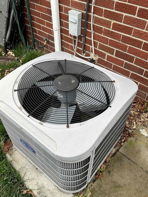 Conducted comprehensive full system HVAC estimate for 15-year-old Carrier equipment replacement. Evaluated existing outdoor condenser unit positioned on concrete pad adjacent to brick exterior, noting refrigerant line routing and electrical disconnect configuration. Assessed basement-mounted air handler with associated ductwork infrastructure, including flexible duct connections and supply plenum configuration. Documented current system layout, equipment positioning, and existing installation conditions to provide accurate replacement system specifications and installation requirements for complete HVAC system upgrade.