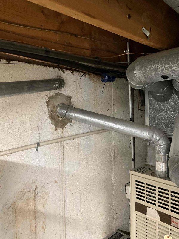 Conducted comprehensive full system HVAC estimate for 15-year-old Carrier equipment replacement. Evaluated existing outdoor condenser unit positioned on concrete pad adjacent to brick exterior, noting refrigerant line routing and electrical disconnect configuration. Assessed basement-mounted air handler with associated ductwork infrastructure, including flexible duct connections and supply plenum configuration. Documented current system layout, equipment positioning, and existing installation conditions to provide accurate replacement system specifications and installation requirements for complete HVAC system upgrade.