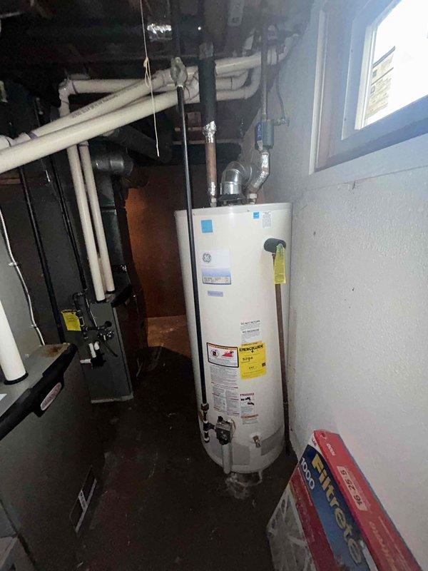 Conducted on-site assessment for heat pump replacement in basement mechanical room. Evaluated existing HVAC equipment, electrical service panel capacity with available breaker positions, and utility room layout including clearances around water heater and furnace. Documented current system configuration, electrical infrastructure, and installation requirements. Photographed mechanical equipment locations, PVC condensate routing, and electrical panel to determine compatibility and sizing specifications for new heat pump system installation.