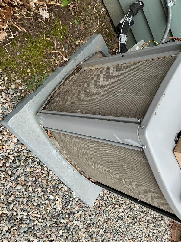 Completed annual comprehensive maintenance on outdoor HVAC condensing unit. Inspected coil panels which showed significant accumulation of dirt, dust, and debris requiring cleaning. Verified unit operation, checked refrigerant lines and electrical connections, and documented equipment condition with photographic evidence for service records.