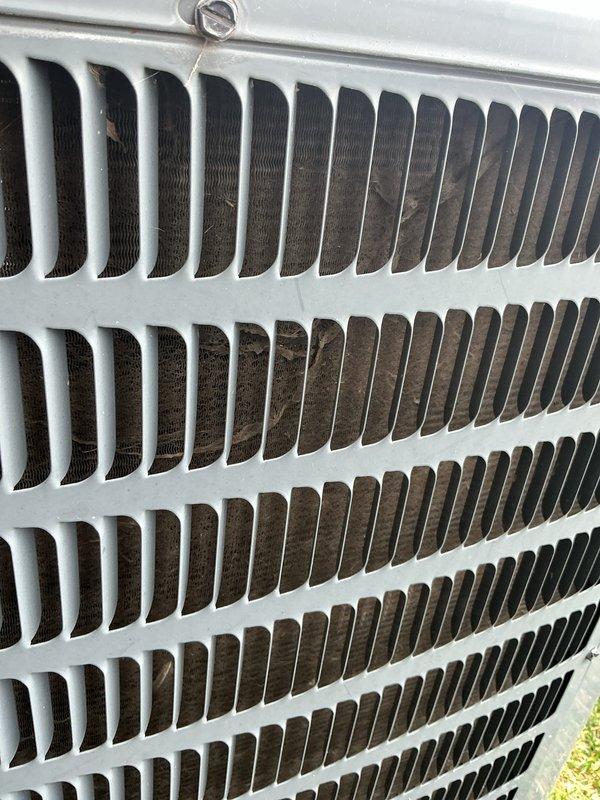 Completed annual maintenance on outdoor condensing unit. Performed visual inspection of heat exchanger coil assembly and exterior components. Unit operational at time of service. Condenser fins showed moderate accumulation of debris and discoloration, indicating normal wear from outdoor exposure. Documented equipment condition with photographs for service records.