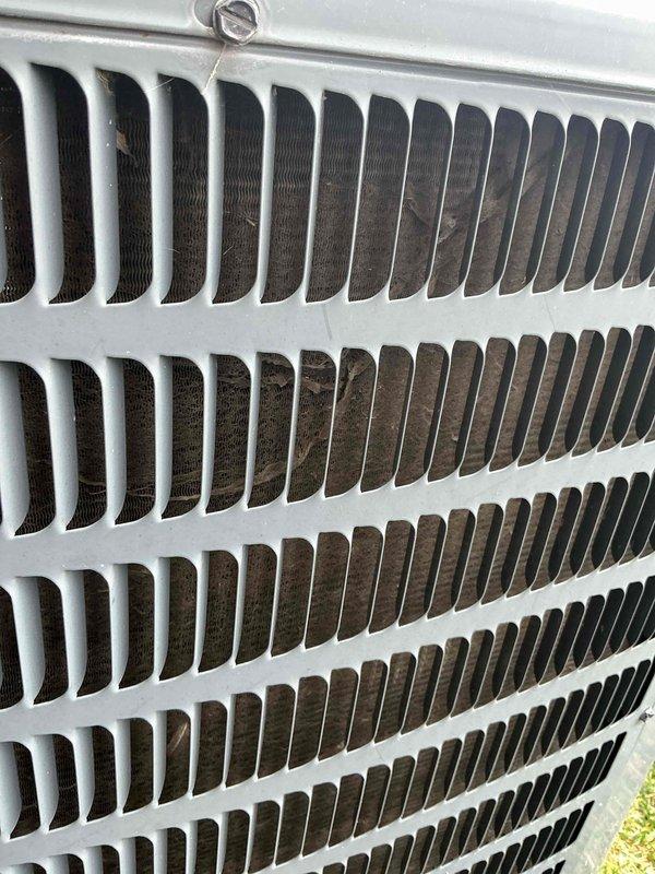 Completed annual maintenance on outdoor condensing unit. Performed visual inspection of heat exchanger coil assembly and exterior components. Unit operational at time of service. Condenser fins showed moderate accumulation of debris and discoloration, indicating normal wear from outdoor exposure. Documented equipment condition with photographs for service records.