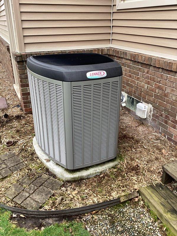 Completed annual cooling maintenance on residential Lennox air conditioning system. Performed comprehensive inspection of outdoor condenser unit, noting dirt and debris accumulation on horizontal condenser coil fins that required cleaning to restore proper airflow efficiency. Documented equipment condition with photos showing typical outdoor weathering and algae growth on concrete pad, with unit maintaining structural integrity throughout service period.