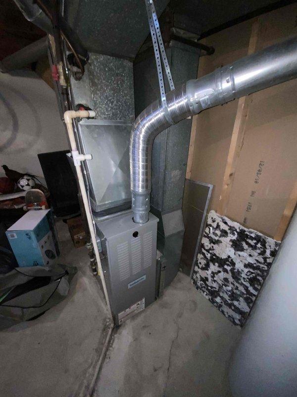 Conducted comprehensive site assessment for HVAC system replacement at residential property with 16-year-old air conditioning unit requiring replacement within the next couple of weeks. Evaluated existing furnace installation in basement utility space and exterior AC condenser unit positioned on concrete pad adjacent to patio area. Documented current equipment configuration, ductwork connections, and electrical service to provide accurate replacement system specifications and installation requirements for complete cooling system upgrade.