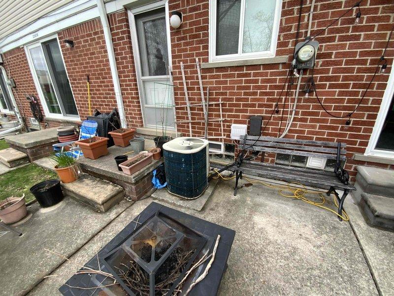Conducted comprehensive site assessment for HVAC system replacement at residential property with 16-year-old air conditioning unit requiring replacement within the next couple of weeks. Evaluated existing furnace installation in basement utility space and exterior AC condenser unit positioned on concrete pad adjacent to patio area. Documented current equipment configuration, ductwork connections, and electrical service to provide accurate replacement system specifications and installation requirements for complete cooling system upgrade.