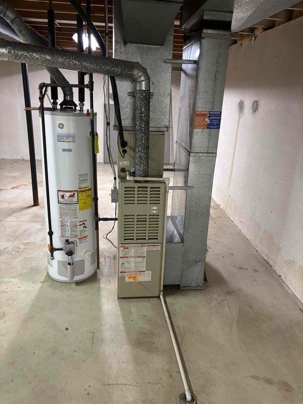 Provided comprehensive estimate for complete HVAC system replacement including natural gas furnace and air conditioning unit for 45-year-old equipment located in basement. Assessed existing beige furnace cabinet and outdoor condenser units positioned against exterior brick wall, documented current system configuration including ductwork, electrical connections, and clearances. Presented replacement options to occupant for both heating and cooling equipment to address aging system concerns.