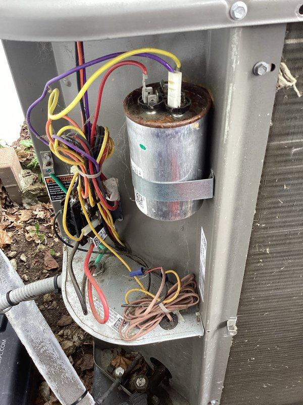 Completed annual cooling maintenance on residential air conditioning system. Performed comprehensive inspection of outdoor condensing unit, including visual examination of capacitor showing age-related corrosion and oxidation on terminals, contactor assembly with multiple wire connections, and electrical components within unit housing. All wiring connections, terminal screws, and internal contacts were inspected for proper operation and safety compliance.