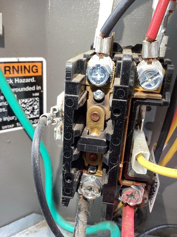 Completed annual cooling maintenance on residential air conditioning system. Performed comprehensive inspection of outdoor condensing unit, including visual examination of capacitor showing age-related corrosion and oxidation on terminals, contactor assembly with multiple wire connections, and electrical components within unit housing. All wiring connections, terminal screws, and internal contacts were inspected for proper operation and safety compliance.