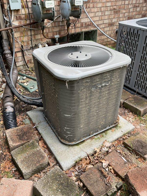 # HVAC Maintenance - ACM Completed

Performed comprehensive annual preventive maintenance on residential air conditioning system. Conducted thorough inspection of outdoor condenser unit, noting significant weathering and exterior discoloration consistent with age and environmental exposure. Assessed unit operation and verified proper function of all major components including compressor, condenser fan motor, and electrical connections.

Inspected refrigerant line sets running from condenser to building, checking for proper insulation and secure mounting. Examined electrical disconnect, conduit routing, and wall-mounted meter connections for code compliance and safe operation. Evaluated concrete pad stability and unit leveling to ensure proper drainage and equipment support.

Noted accumulation of organic debris including leaves and moss growth on equipment pad and surrounding pavers. Documented presence of multiple HVAC units serving the property. All systems operational with no immedi