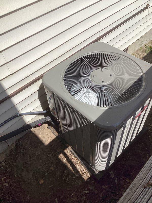 Completed full HVAC system installation including a Lennox 70,000 BTU furnace with PVC venting and a 2.5 ton air conditioning condenser unit with rear discharge configuration. Installed furnace in basement utility area with proper ductwork connections, applied liner, and completed all refrigerant line connections to outdoor condenser unit positioned on concrete pad. Obtained mechanical and refrigeration permits, reconnected all utilities, and finalized all required paperwork for system operation.