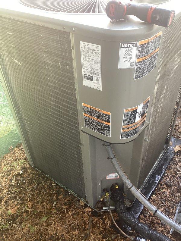 Completed scheduled air conditioning maintenance on residential split system. Performed comprehensive inspection of outdoor condenser unit and associated components including water heater connection points. Verified refrigerant line connections, checked electrical components, and inspected fan motor operation. All warning labels and manufacturer specifications confirmed visible and intact. System operating within normal parameters with no deficiencies noted at time of service.