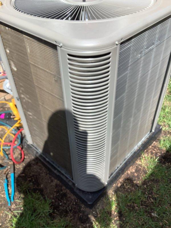 Completed annual preventative maintenance and tune-up on residential air conditioning condenser unit. Connected manifold gauges to measure system pressures, inspected exterior housing and louvers for damage, verified fan operation, and documented unit condition with photographs. All components found operating within normal parameters.