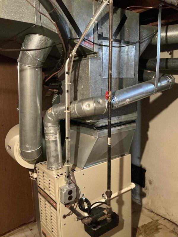 Conducted comprehensive estimate for complete HVAC system replacement in basement location. Existing 27-year-old natural gas furnace and air conditioning system non-operational and beyond serviceable life. Assessed current basement installation including furnace cabinet, ductwork configuration, venting system, and electrical connections. Evaluated outdoor condensing unit location and electrical service requirements. Documented existing galvanized metal ductwork, gas supply lines with shutoff valve, and concrete block foundation conditions. Photographed current equipment layout to determine optimal replacement configuration and identify any necessary modifications to accommodate new high-efficiency system. Provided detailed replacement recommendations for both heating and cooling equipment appropriate for natural gas fuel source.