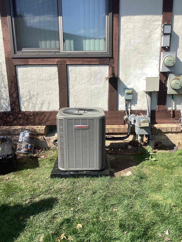 Successfully completed installation of a 2-ton air conditioning system with matching evaporator coil at rear of residence. Installed new Coleman outdoor condensing unit on grade-level pad adjacent to building exterior, connected refrigerant lines to indoor coil mounted above existing Lennox furnace in basement mechanical room. Completed all electrical connections including disconnect box and reconnection to existing power supply. All mechanical, electrical, and air conditioning permits obtained and work performed to code specifications.