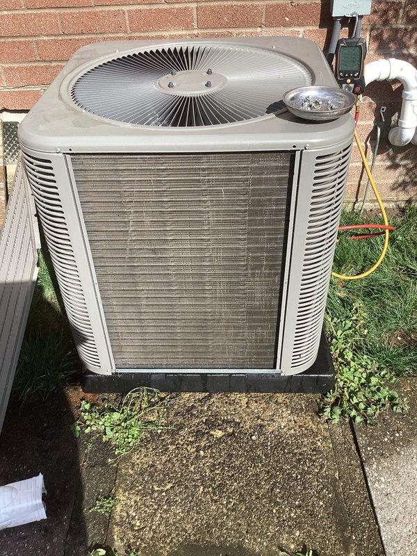 Completed scheduled air conditioning maintenance on outdoor condenser unit. Performed comprehensive system diagnostics using digital multimeter to verify electrical performance and operational parameters. Inspected condenser coils, fan assembly, and cabinet condition, noting normal weathering consistent with outdoor installation. Unit operating within manufacturer specifications at time of service.