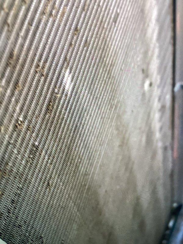 Completed routine Air Care Cooling maintenance inspection on HVAC system. Documented current condition of evaporator coil and condenser fins, which showed significant accumulation of dust, dirt, and debris throughout the fin assembly, though unit maintained structural integrity and operational status.