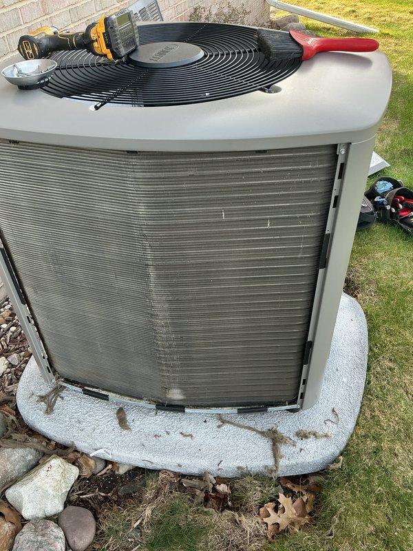 # HVAC Maintenance Summary

Completed annual cooling maintenance on residential air conditioning system. Performed comprehensive inspection of outdoor condenser unit, including cleaning of coil fins which showed moderate dirt and debris accumulation. Replaced air filters as needed and addressed routine maintenance requirements to ensure optimal system performance for the upcoming cooling season.

# Detailed Work Performed

Arrived on site and performed scheduled annual cooling maintenance on residential split system air conditioner. Conducted thorough visual inspection of outdoor condenser unit, noting accumulation of dirt, debris, and organic material on condenser coil surfaces and surrounding area.

Removed top fan grille assembly to access internal components. Inspected fan motor, blades, and electrical connections for proper operation and signs of wear. Verified fan motor operation and checked for unusual noise or vibration. Cleaned condenser coil fins using appropriate cleaning me